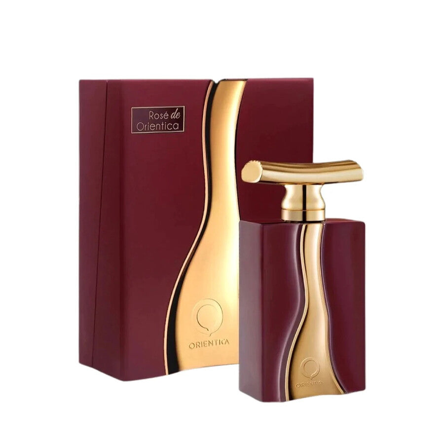 Maroon and gold perfume bottle with packaging on a white background