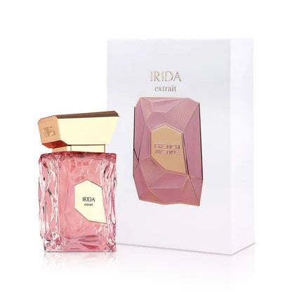 Pink perfume bottle with gold accents and matching box on a white background