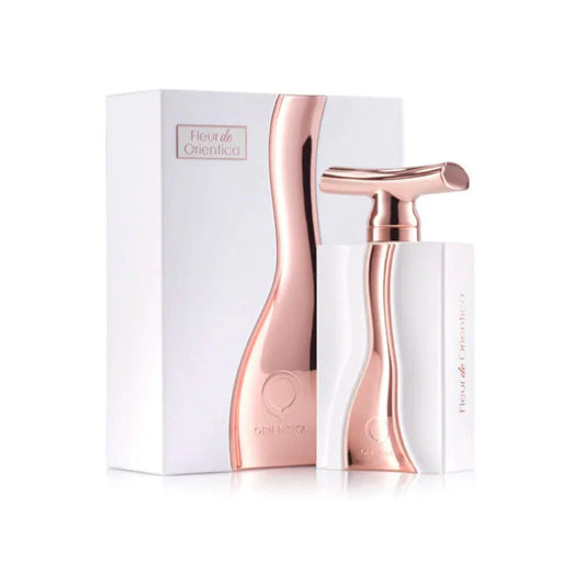 Rose gold perfume bottle and packaging on a white background